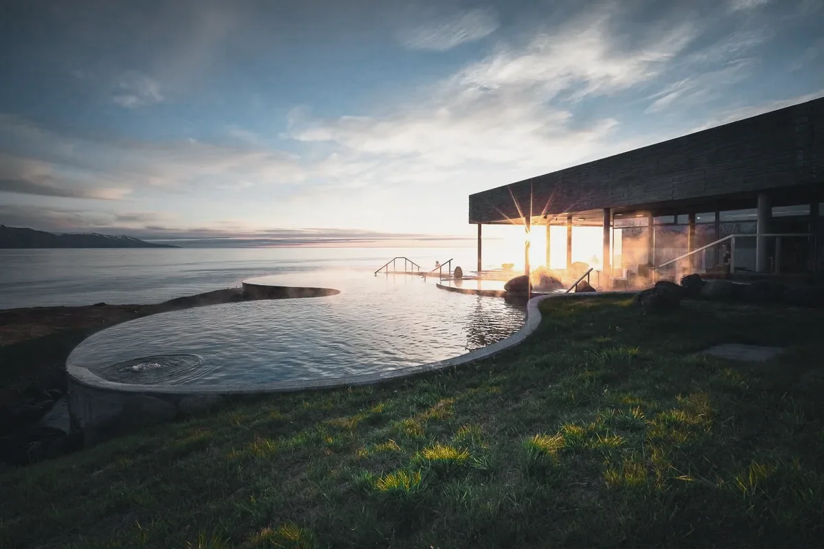 Geothermal sea baths on a grassy clifftop above the bay